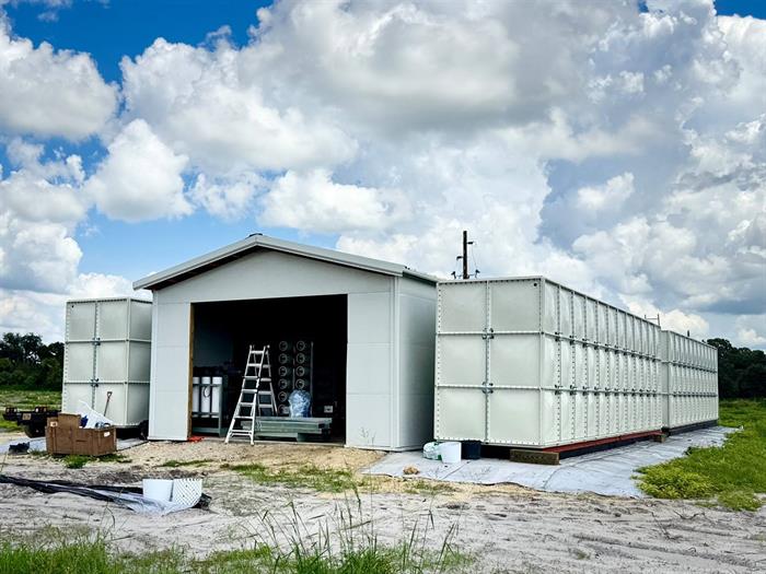 The finished treatment building with the water tank bank alongside it.