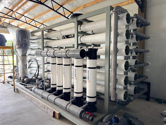 The reverse osmosis skid, rows of membrane pressure vessels on a steel frame.